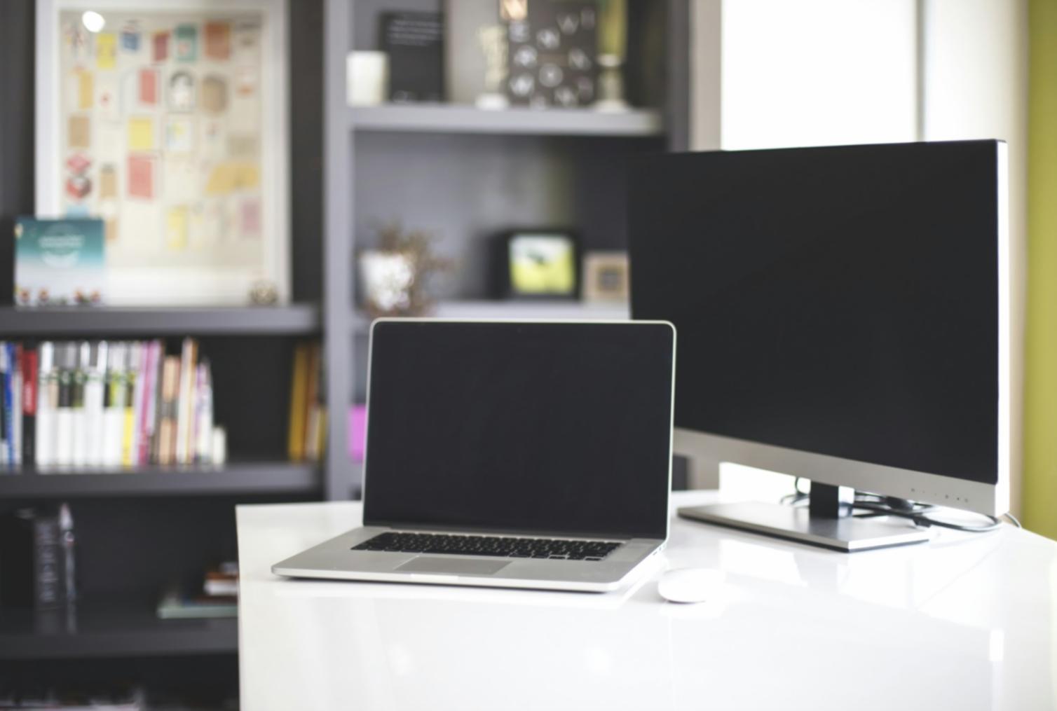 Professional analyzing financial statements with charts and graphs displayed on computer screens